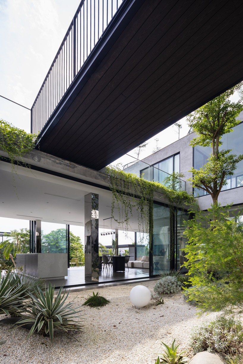 garden courtyards wind through stacked cubes of idee architects' vietnam hillside house