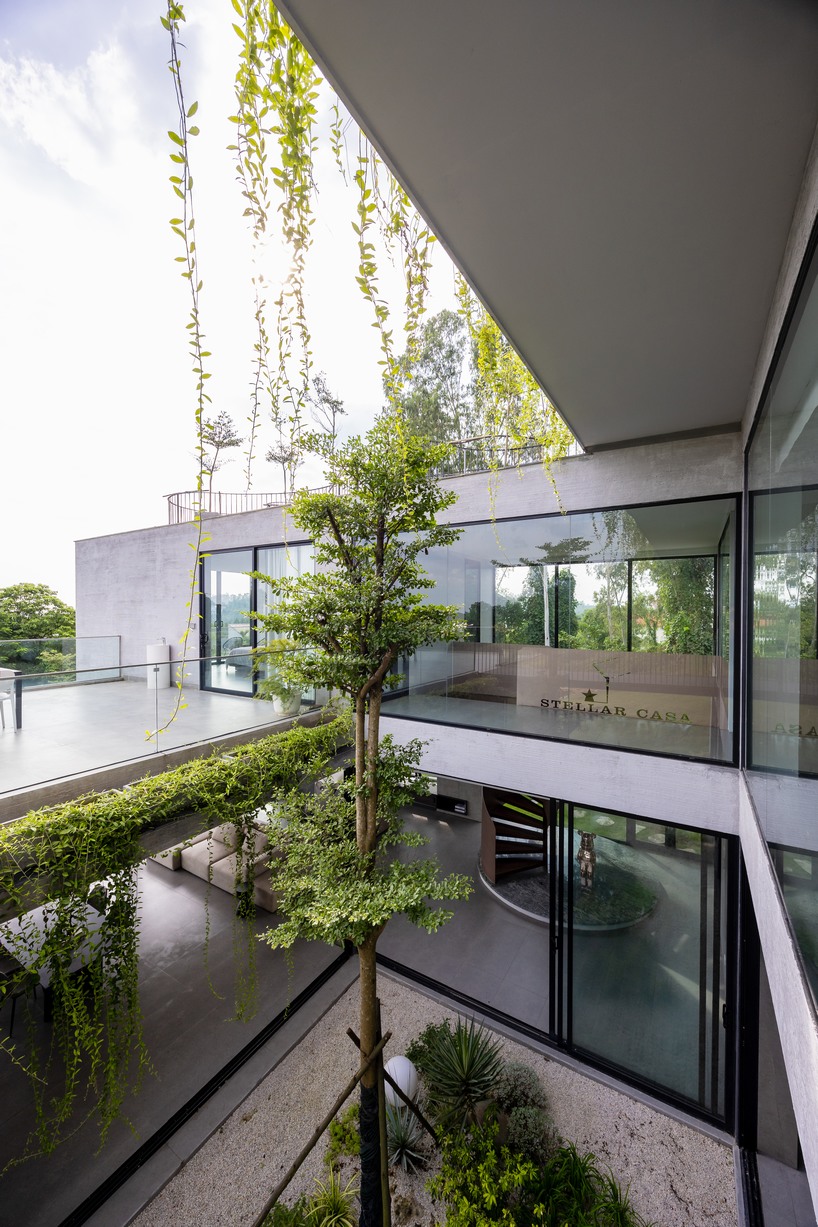 garden courtyards wind through stacked cubes of idee architects' vietnam hillside house