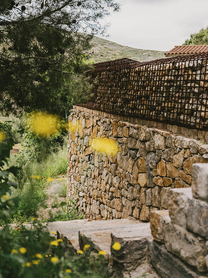 concrete masses, rusted steel + stones blend this promenade into the spanish landscape