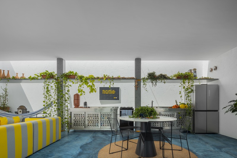 white perforated cubic facade wraps hybrid home and studio around a tree in brazil - 6