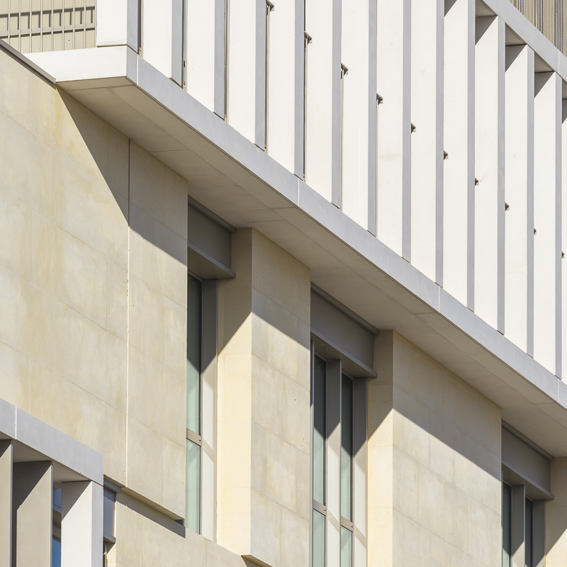 interlocking stone volumes sculpt layered school complex by brenac & gonzalez & associés
