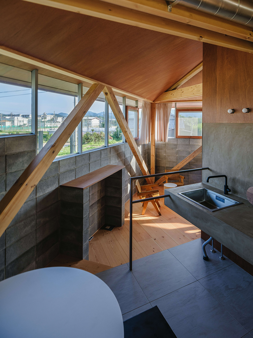 concrete blocks and angled timber beams shape up weekend house in kyoto