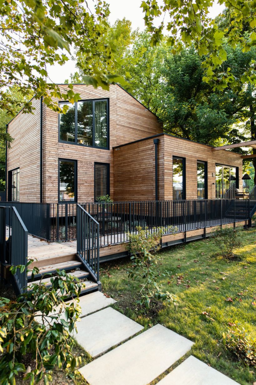 four wooden stilted structures host zero-emission resort's suites amongst centuries-old trees