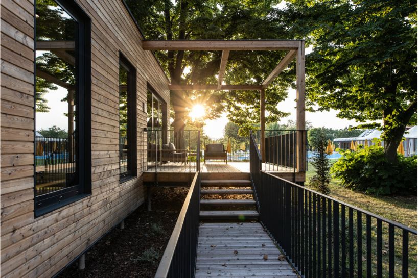 four wooden stilted structures host zero-emission resort's suites amongst centuries-old trees