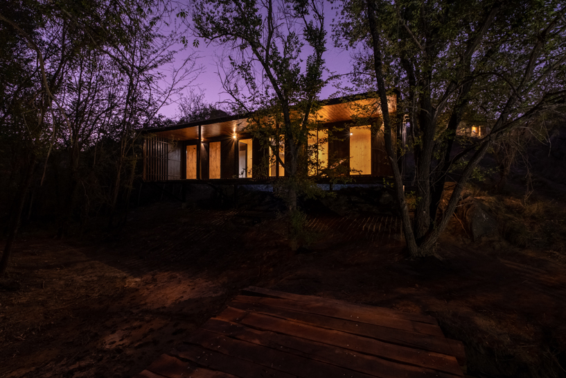 'little house on the river' forms an elevated shelter on a steep-sloping plot in argentina