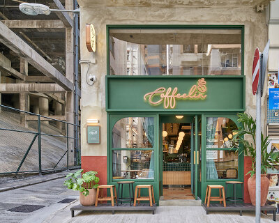 dark green elements + antique finish characterize this milanese-style coffee shop in hong kong