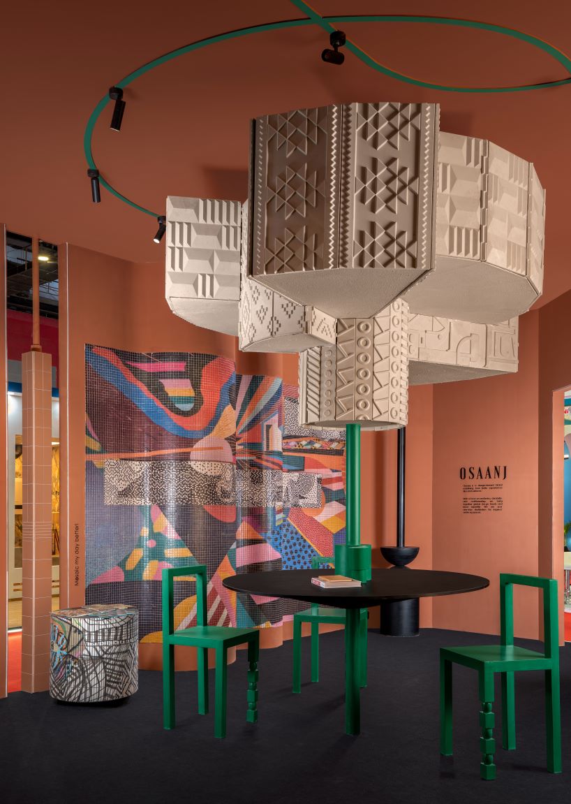 patterned tiles extend from curved walls to furniture in layered retail exhibition booth