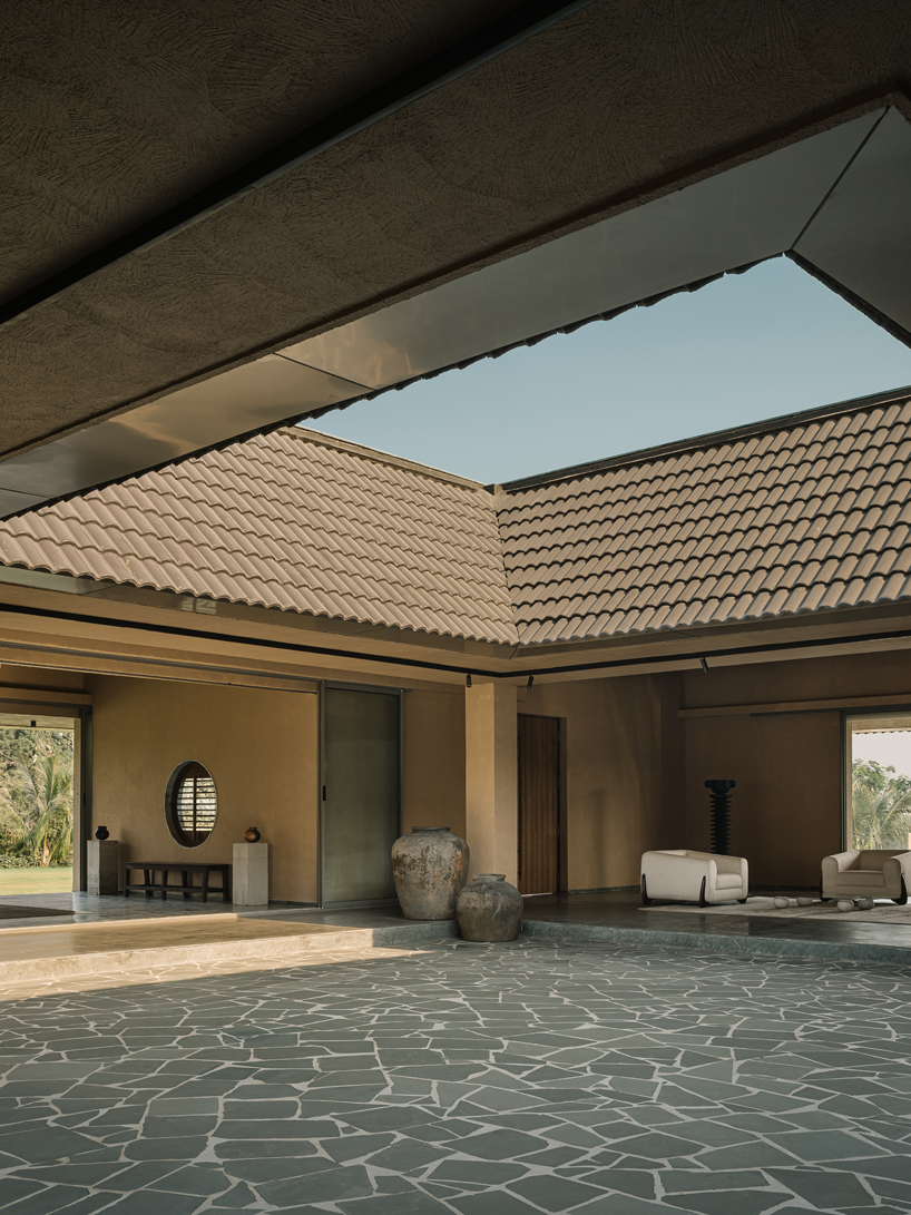 sculpted shell of stone and plaster encircles courtyard house by d’well in india