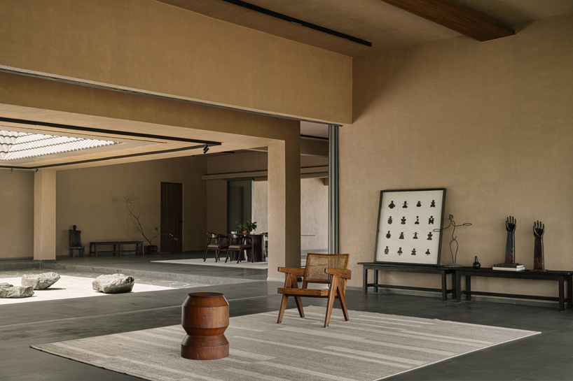 sculpted shell of stone and plaster encircles courtyard house by d’well in india