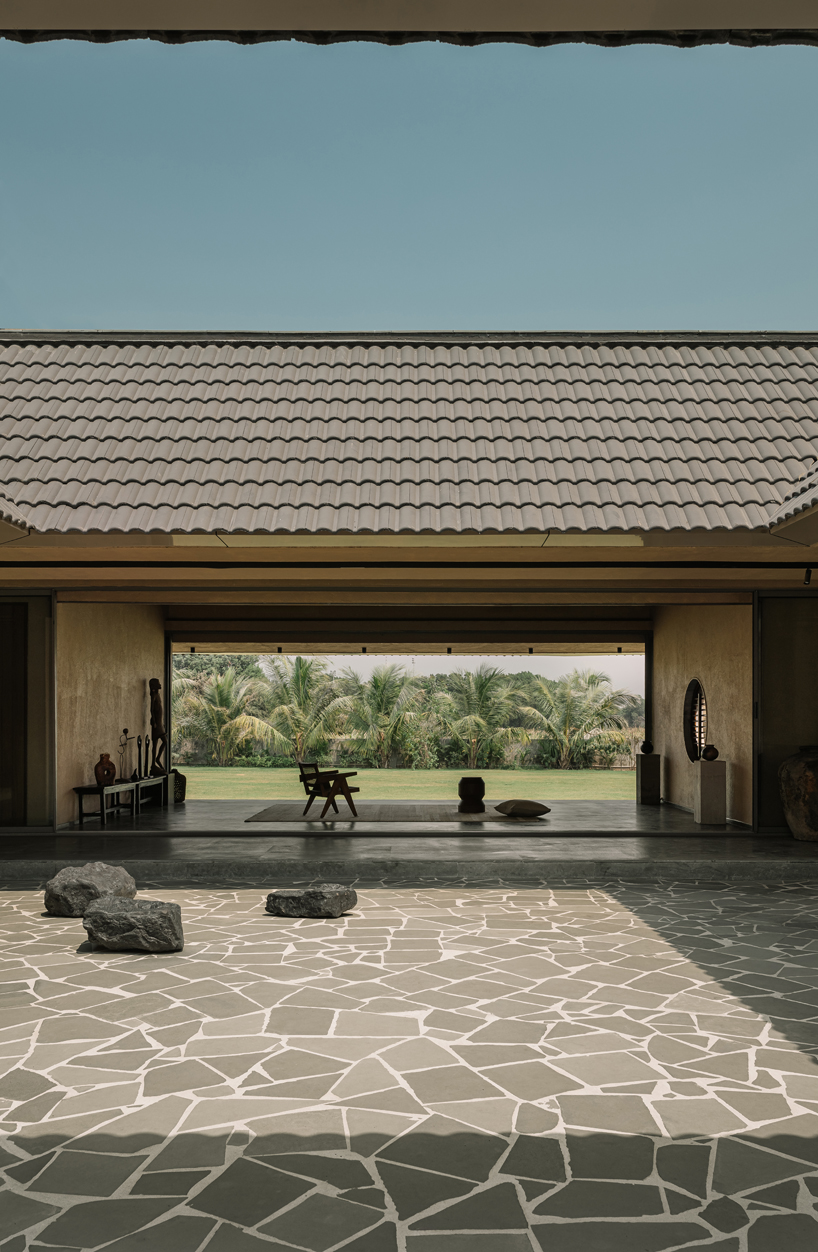 sculpted shell of stone and plaster encircles courtyard house by d’well in india