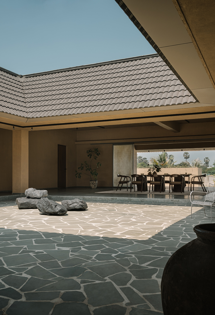 sculpted shell of stone and plaster encircles courtyard house by d’well in india