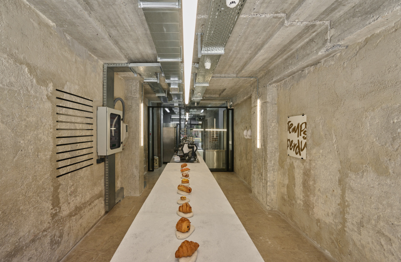 transparent facade reveals bakery's raw industrial interiors by saint of athens