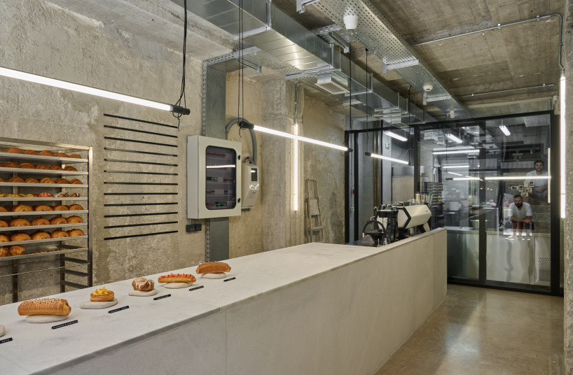 transparent facade reveals bakery's raw industrial interiors by saint of athens