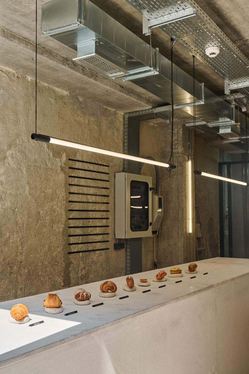 transparent facade reveals bakery's raw industrial interiors by saint of athens