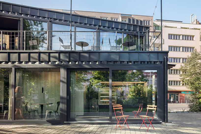 this industrial cafe in prague is made of gray recycled shipping containers