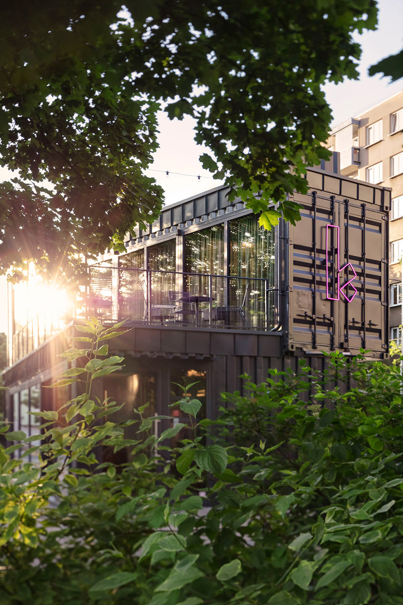 this industrial cafe in prague is made of gray recycled shipping containers