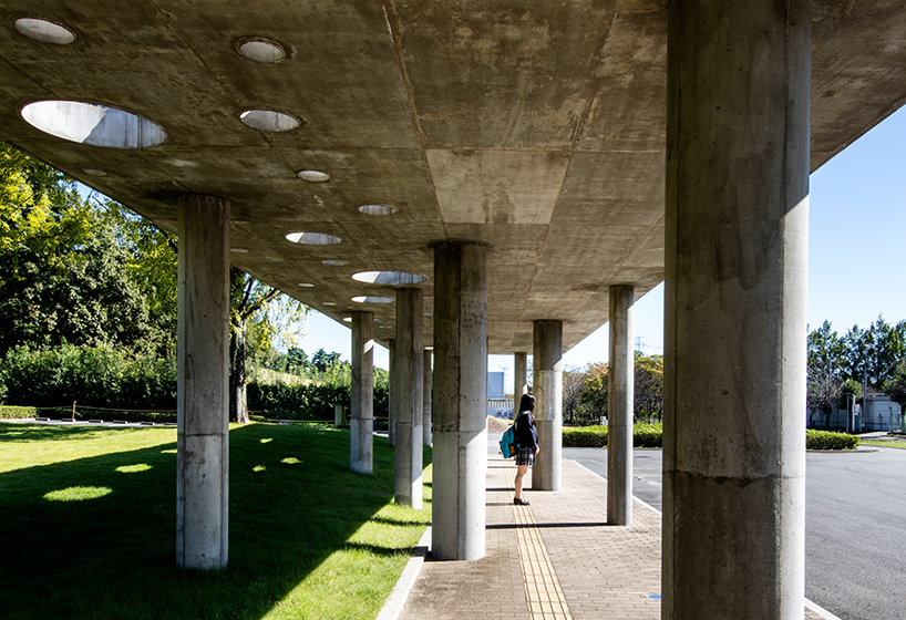 small and large holes peek through brutalist high school gymnasium in japan