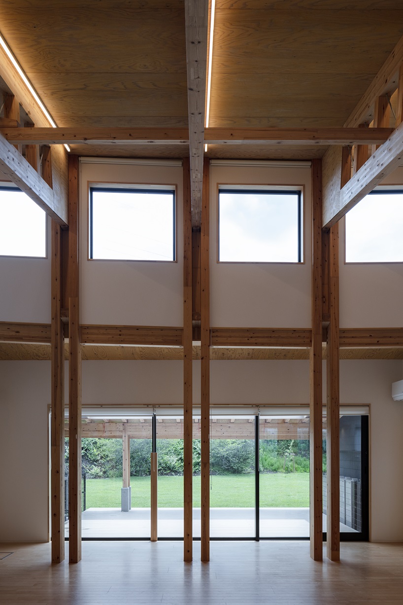 twin leaf-shaped roofs unfold atop nursery school by NIKKEN SEKKEI in japan
