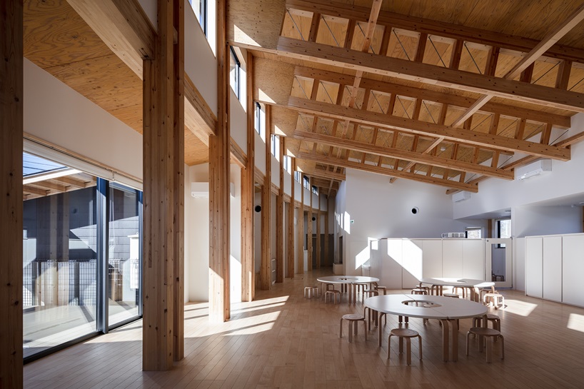 twin leaf-shaped roofs unfold atop nursery school by NIKKEN SEKKEI in japan