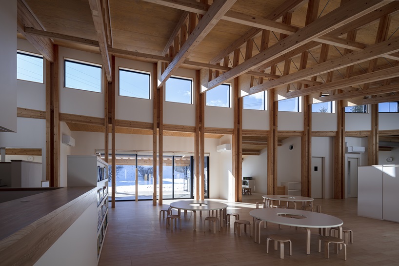 twin leaf-shaped roofs unfold atop nursery school by NIKKEN SEKKEI in japan