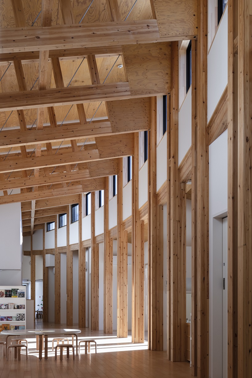 twin leaf-shaped roofs unfold atop nursery school by NIKKEN SEKKEI in japan