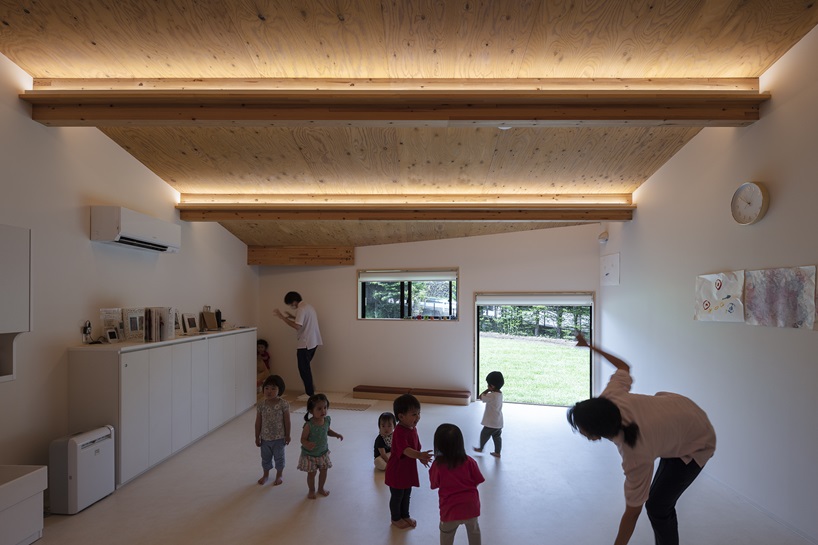 twin leaf-shaped roofs unfold atop nursery school by NIKKEN SEKKEI in japan