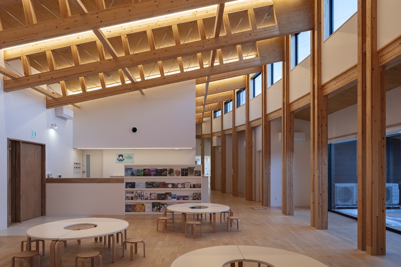 twin leaf-shaped roofs unfold atop nursery school by NIKKEN SEKKEI in japan