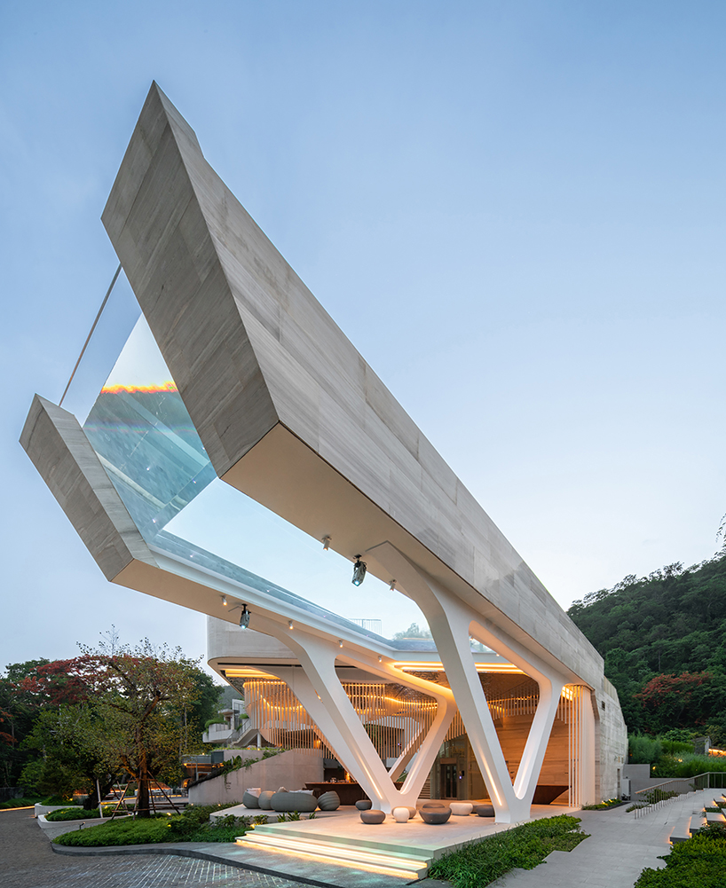 cantilevered transparent pool hovers above hotel complex in thailand