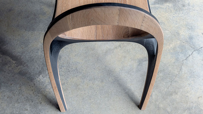 fluid convex and concave shapes take the form of wooden aria chair