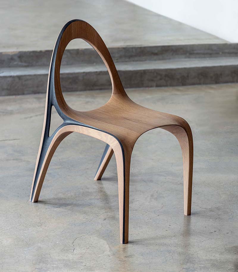 fluid convex and concave shapes take the form of wooden aria chair