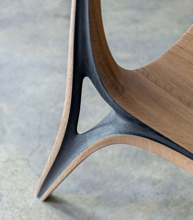 fluid convex and concave shapes take the form of wooden aria chair