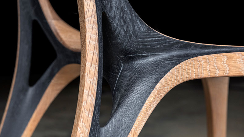 fluid convex and concave shapes take the form of wooden aria chair