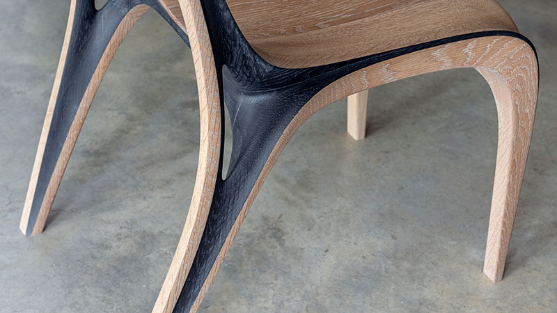 fluid convex and concave shapes take the form of wooden aria chair
