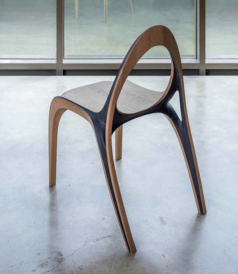fluid convex and concave shapes take the form of wooden aria chair
