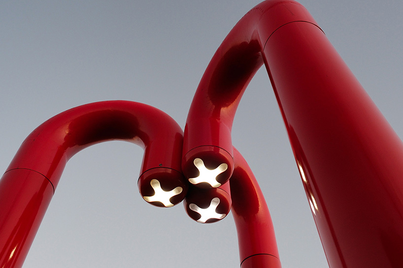 three-legged installation turns industrial gas pipes into intimate public shelter