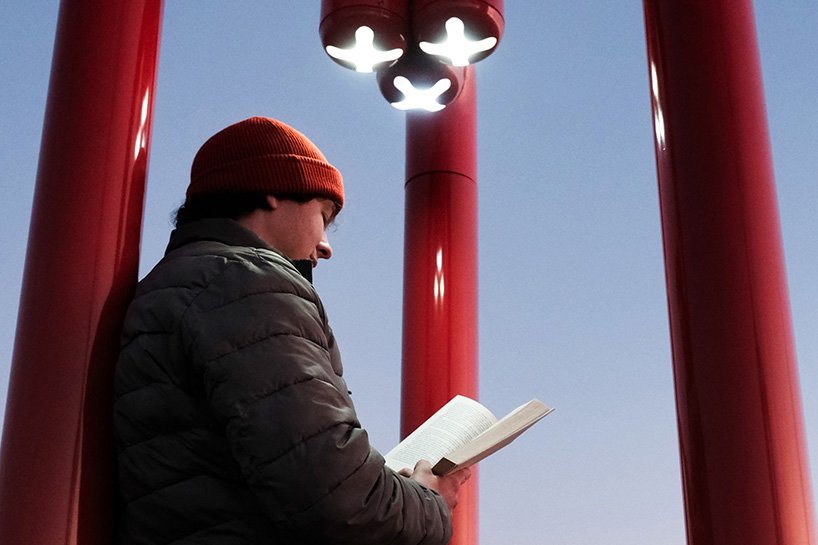 three-legged installation turns industrial gas pipes into intimate public shelter