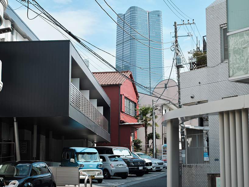 renovated wooden house boasts bright red facade in central tokyo