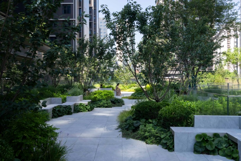 a garden-within-a-garden unfolds through water, translucent pavilions, and green courtyards - 11