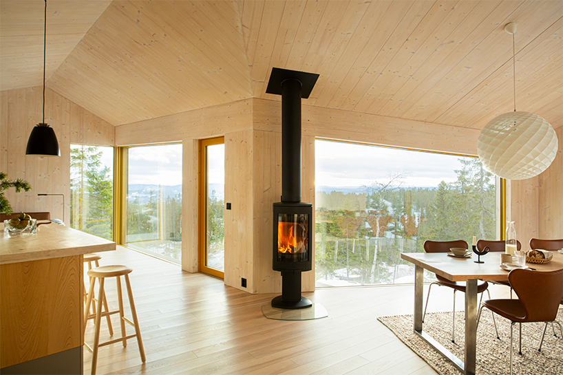 timber-clad cabin in mountainous norway splits into three wings