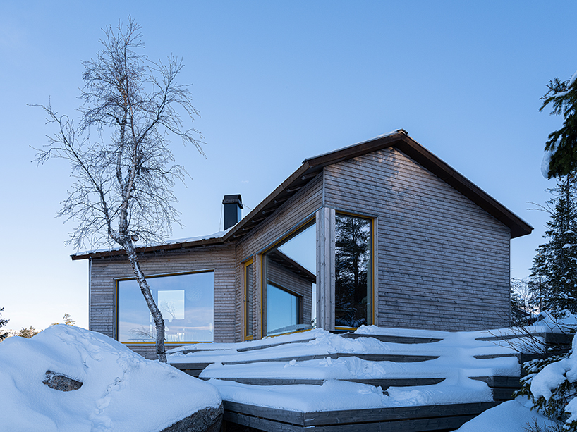 timber-clad cabin in mountainous norway splits into three wings