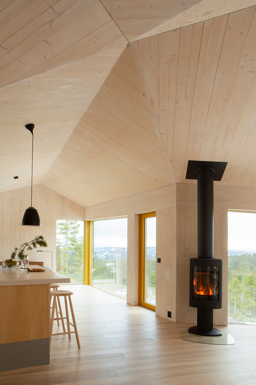 this timber-clad cabin in mountainous norway splits into three wings