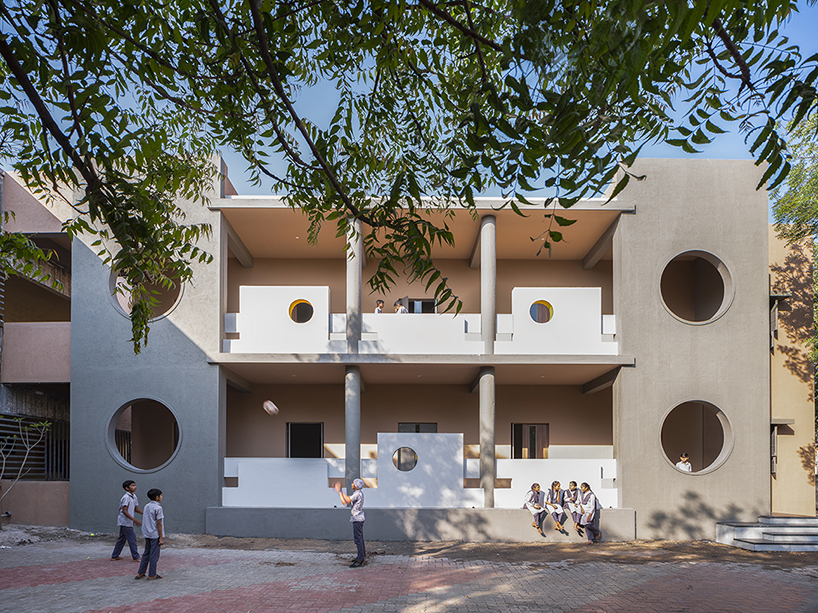 circular openings breathe nature and light into studio dhulia's rural school extension in india