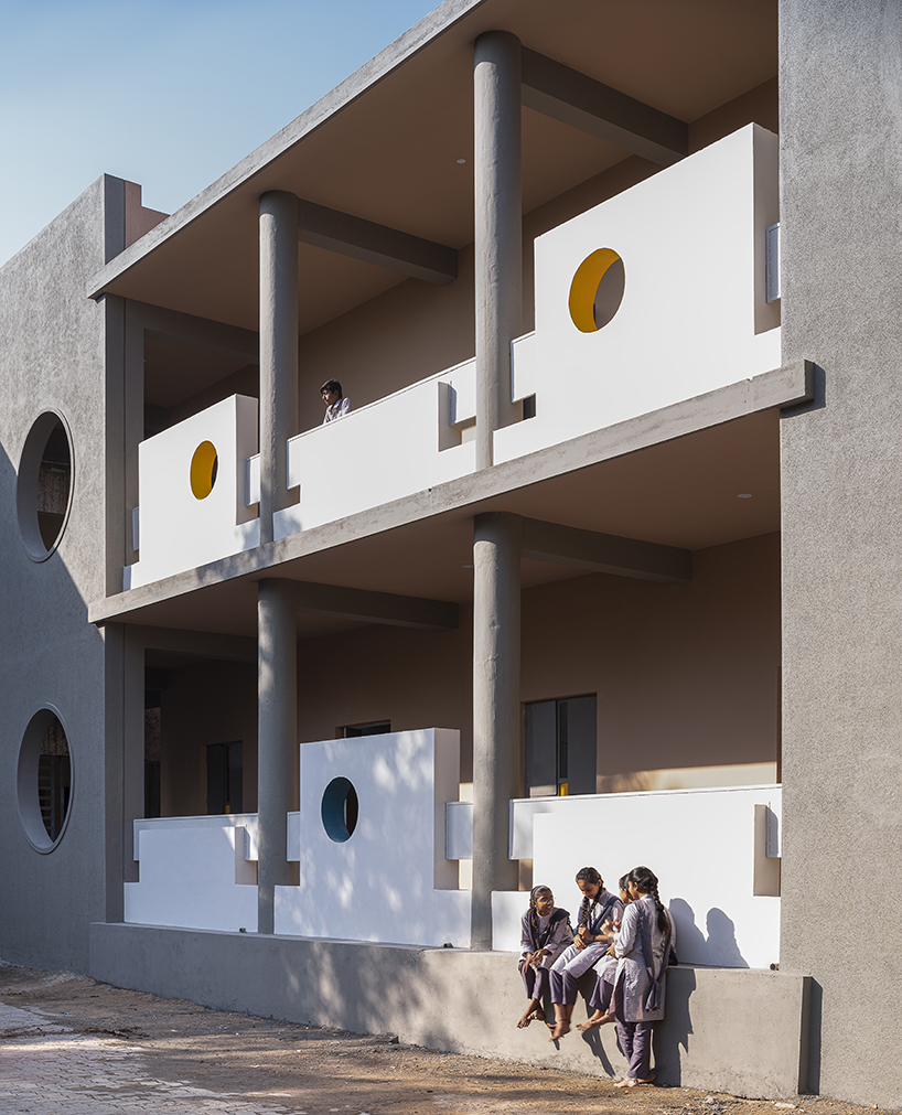 circular openings breathe nature and light into studio dhulia's rural school extension in india