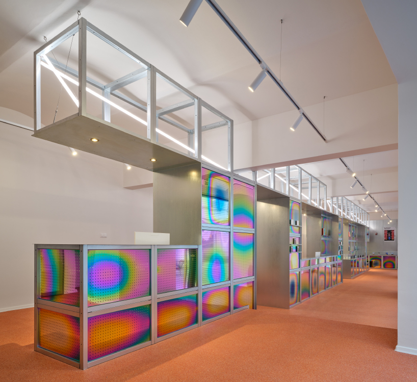 iridescent titanium panels cast chromatic reflections within info desk by KOGAA in brno