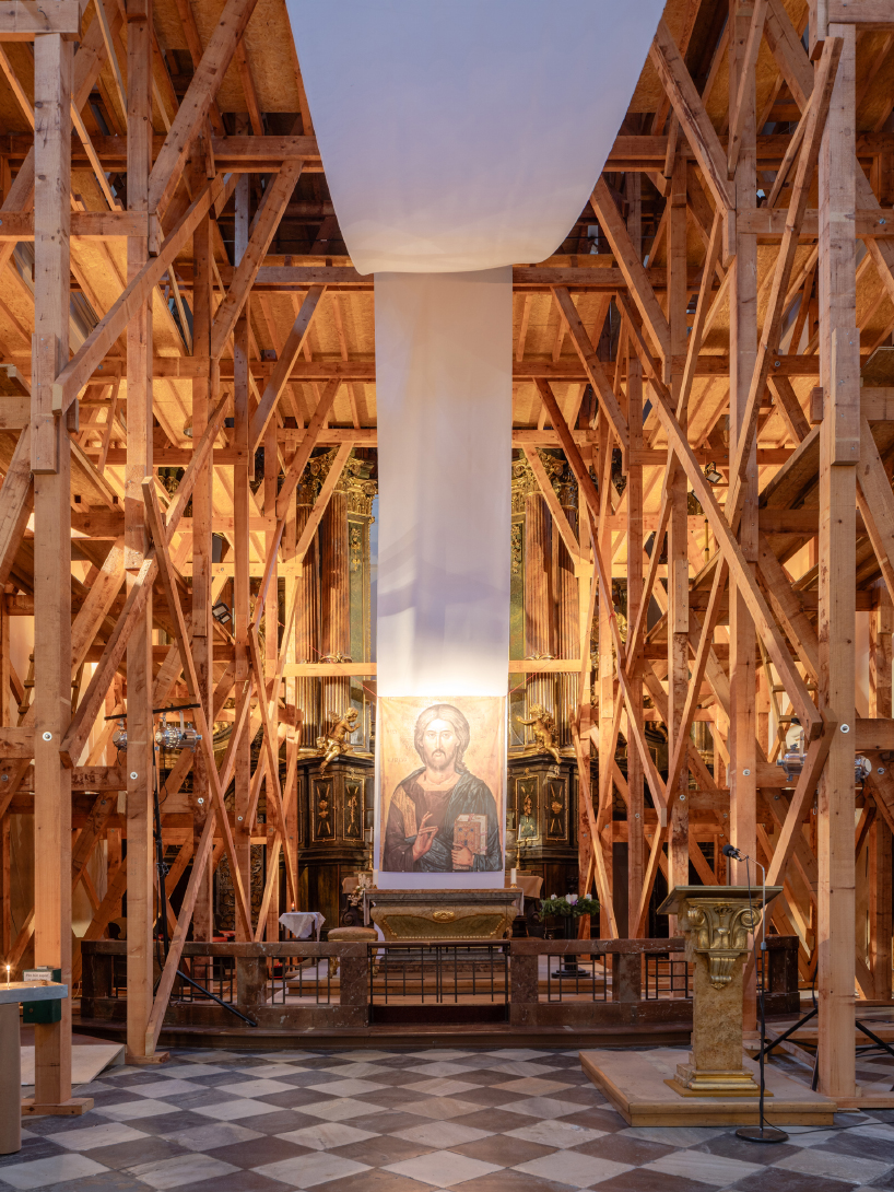 red and white curtains transform czech historic center’s pathways into christmas installation