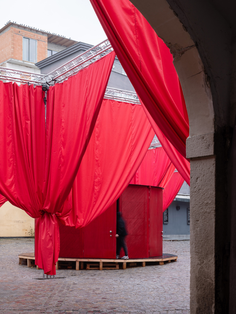 red and white curtains transform czech historic center’s pathways into christmas installation