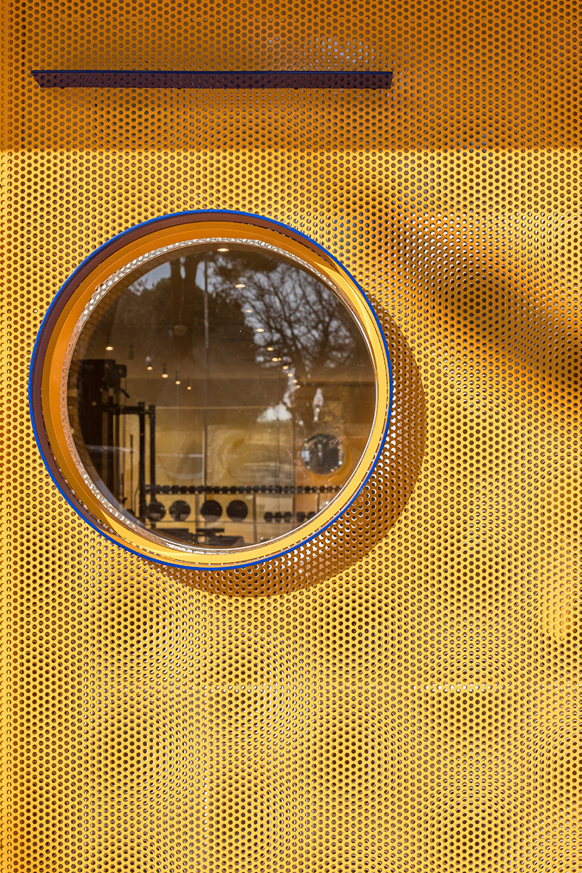 bright orange perforated metal sheets shape a modular fitness center in madrid - 11