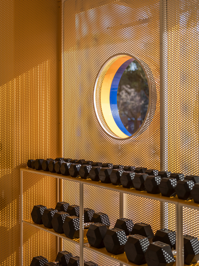 bright orange perforated metal sheets shape a modular fitness center in madrid - 10