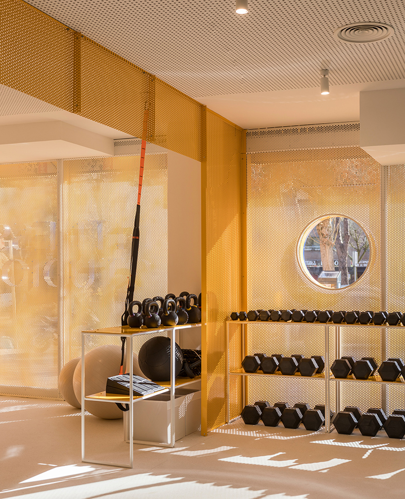bright orange perforated metal sheets shape a modular fitness center in madrid - 7