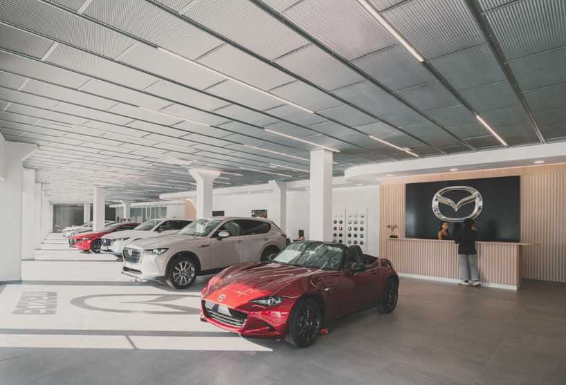 OOIIO wraps reused madrid auto center in permeable skin of vertical metal slats - 10